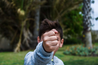 Close-up of baby hand on tree