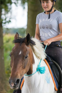 Teenager riding horse