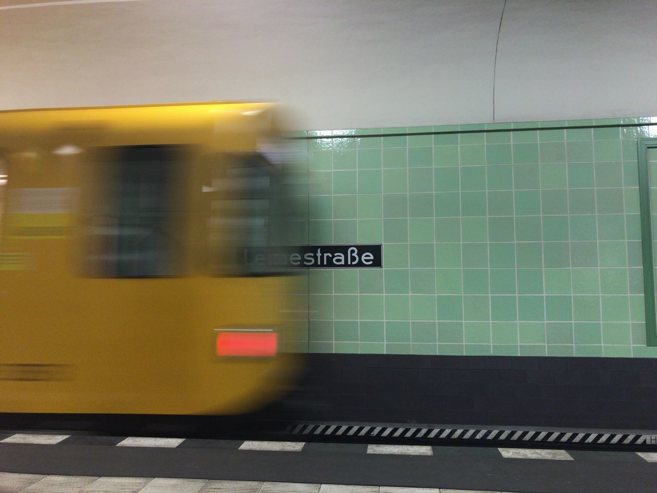 BLURRED MOTION OF YELLOW CAR ON ROAD