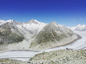 Scenic view of snow covered mountains against clear sky