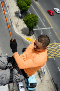 Man with helmet, glove and equipment practicing rappel