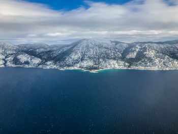 Aerial view of snowcapped mountains against sky