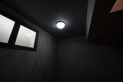 Low angle view of illuminated lights on wall