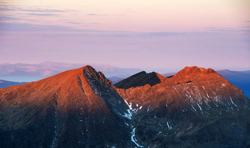 Scenic view of mountains against sky during sunset