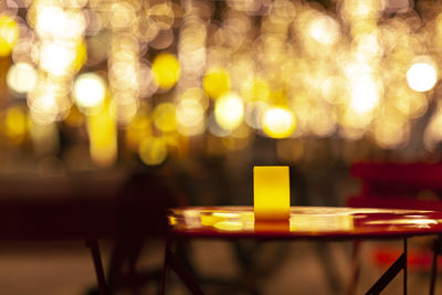 Close-up of illuminated light on table at night