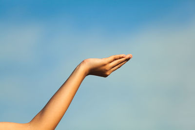 Cropped image of woman gesturing against sky
