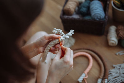 Cropped hand of woman holding rope