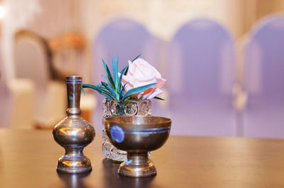 Close-up of flower vase on table at home