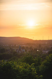 Scenic view of landscape against orange sky