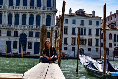 Woman sitting on boat in canal