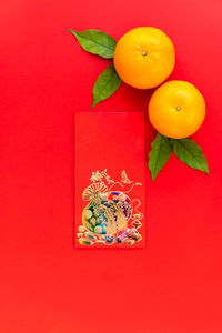 Close-up of orange fruits against red background