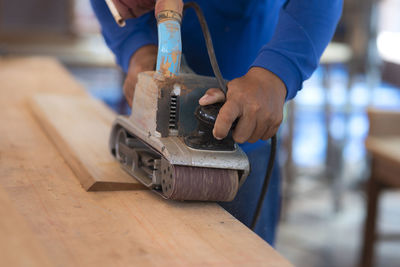 Midsection of worker working in workshop