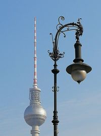 Low angle view of communications tower against sky