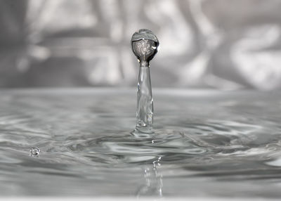 Close-up of drop falling on water surface