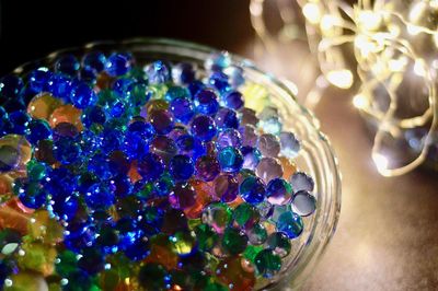 Close-up of multi colored lights on glass table