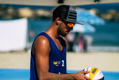 Side view of young man looking at swimming pool