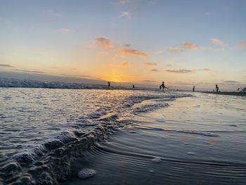 Scenic view of beach against sky during sunset