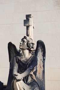 Winged statue against the wall