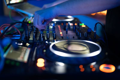 Cropped hand of man using sound mixer