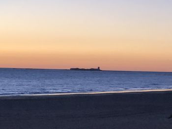 Scenic view of sea against clear sky during sunset