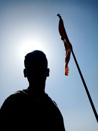 Low angle view of silhouette man against sky