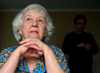 Close-up of thoughtful senior woman sitting at home