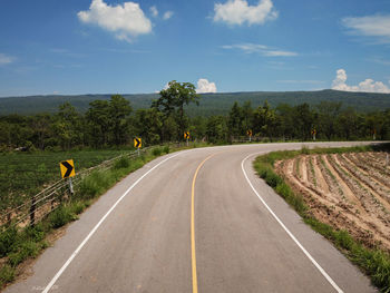 Road passing through landscape against sky