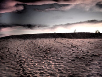 Scenic view of desert against sky during sunset