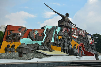 Low angle view of statue against sky