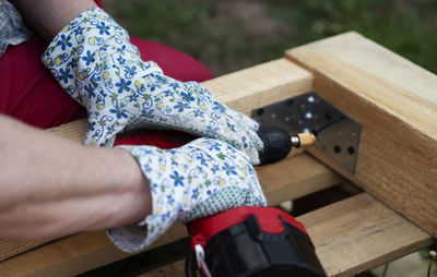 Low section of woman sitting on bench