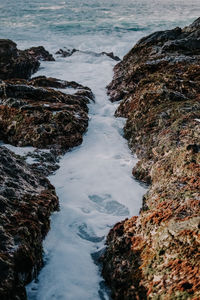 Scenic view of waterfall by rocks