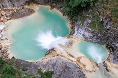 Scenic blue waterfall in the green frost