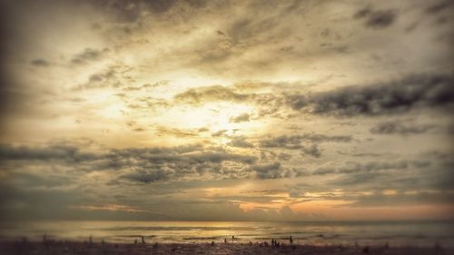 Scenic view of sea against dramatic sky during sunset