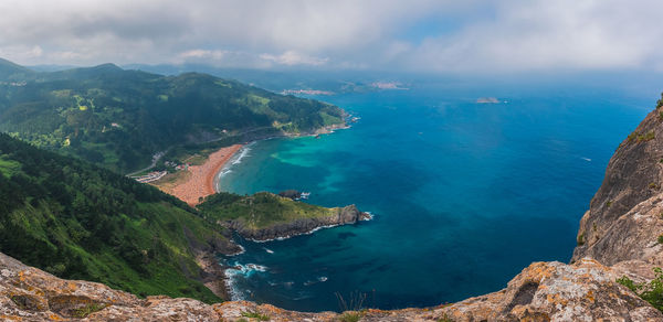 High angle view of sea and mountains against sky