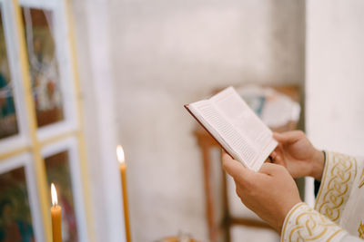 Midsection of woman reading book