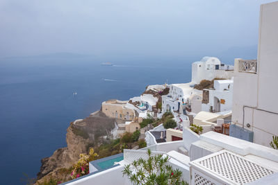 Panorama of houses in the village of oia and the caldera on a rare rainy day, santorini, greece