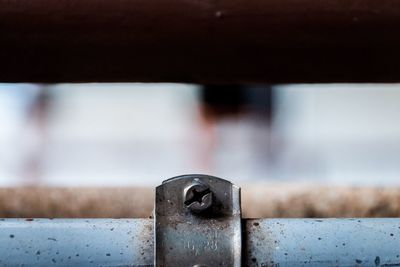 Close-up of screw on old railing