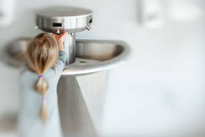 5 years old girl washing her hand in pandemic time