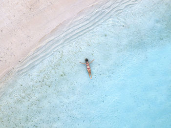 Woman relaxing and swimming in sea at beach