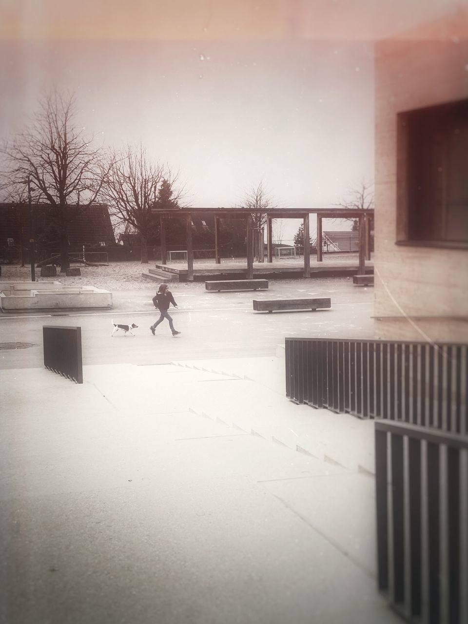 PERSON WALKING ON FOOTPATH IN CITY