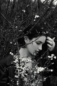 Portrait of woman with pink flowers on tree