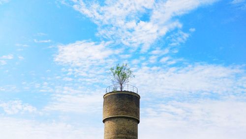 Low angle view of smoke stack against sky