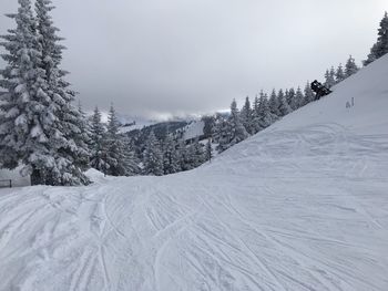 Scenic view of snow covered mountains against sky