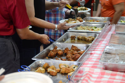 Midsection of man preparing food