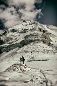 Low angle view of snow covered mountain against sky