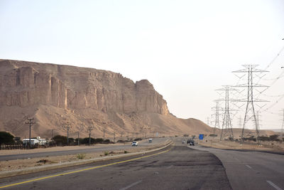 Road by mountain against clear sky