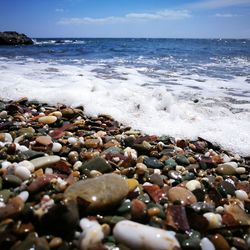 Pebbles on beach against sky