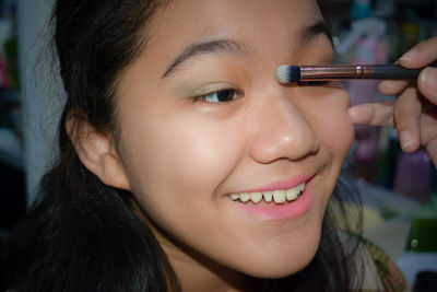 Close-up portrait of a smiling young woman