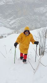 Man with umbrella on snow covered field