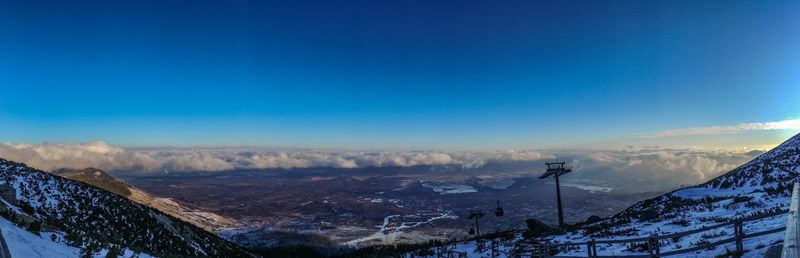 Scenic view of snowcapped mountains against blue sky